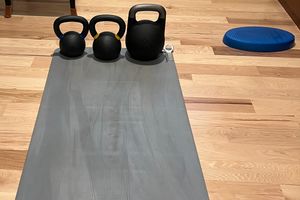 My home gym setup, a yoga mat, some kettlebells, and a balance cushion