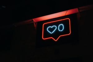 a neon sign with a heart and a zero next to it