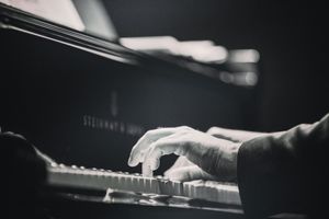 a man playing a Steinway piano