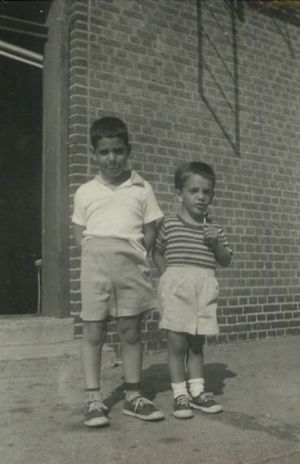 Circa 1960, Bill and I standing outside of our apartment building in Brooklyn.